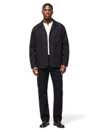 Black canvas chore jacket worn by model, front view on white