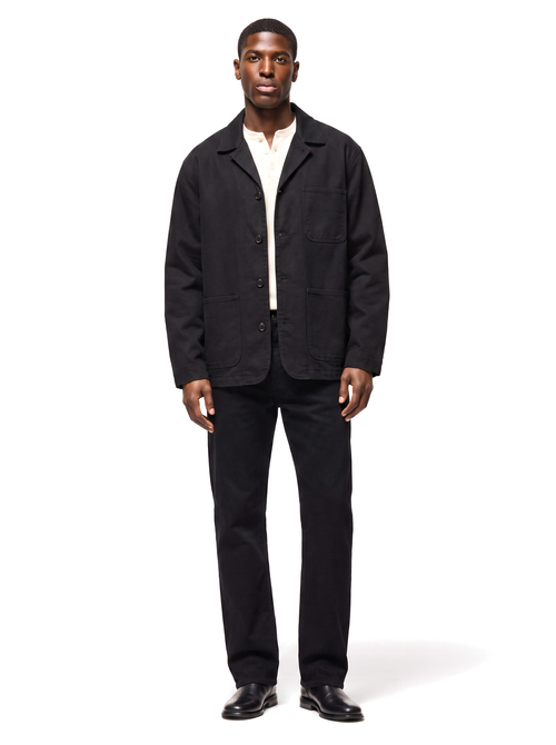 Black canvas chore jacket worn by model, front view on white