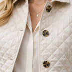 Quilted mid season coat stitching detail