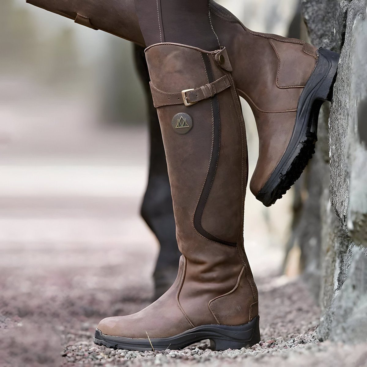 Dark brown leather knee high riding boot with buckle strap