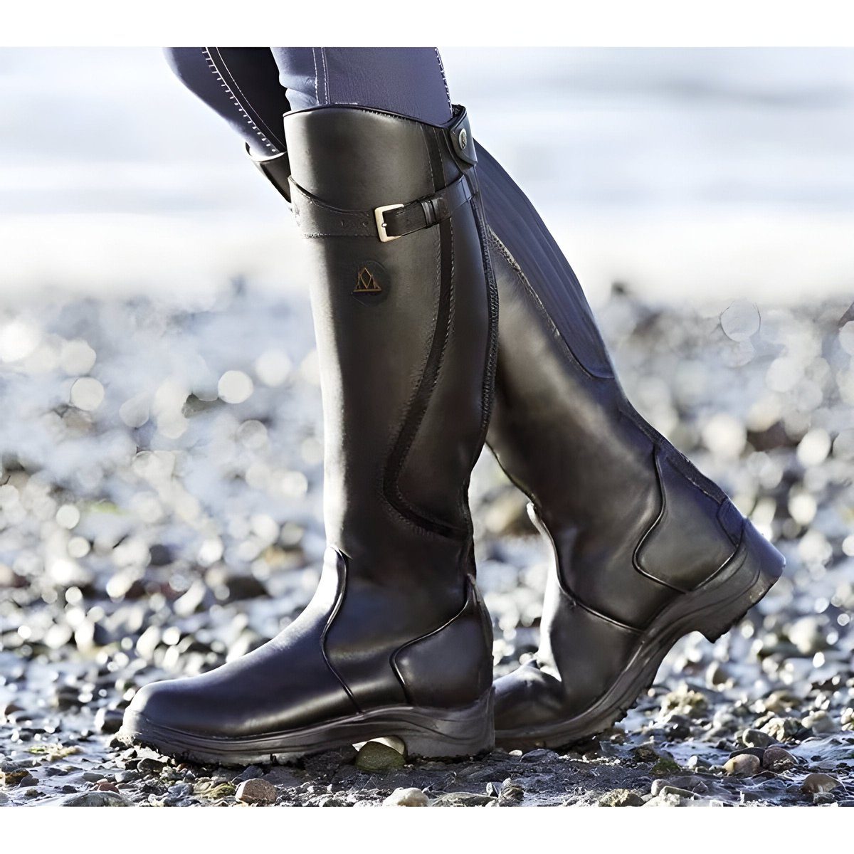 Black leather knee high riding boot with buckle strap