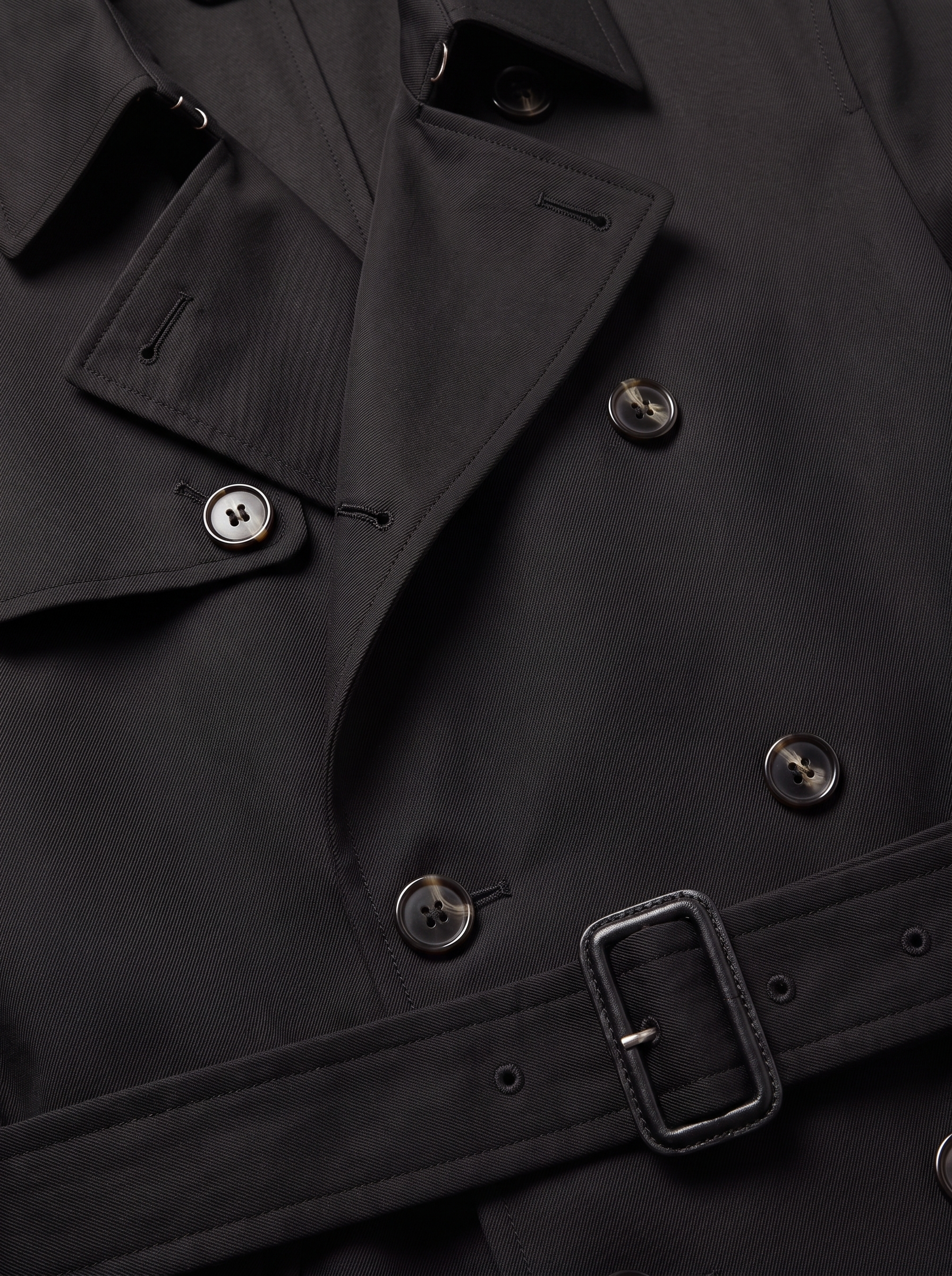 Black trench coat lapel and belt close up detail