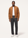 Cognac suede bomber jacket with ribbed collar worn by model, front view on white