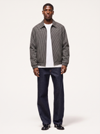 Black and white micro plaid harrington jacket worn by model, front view on white
