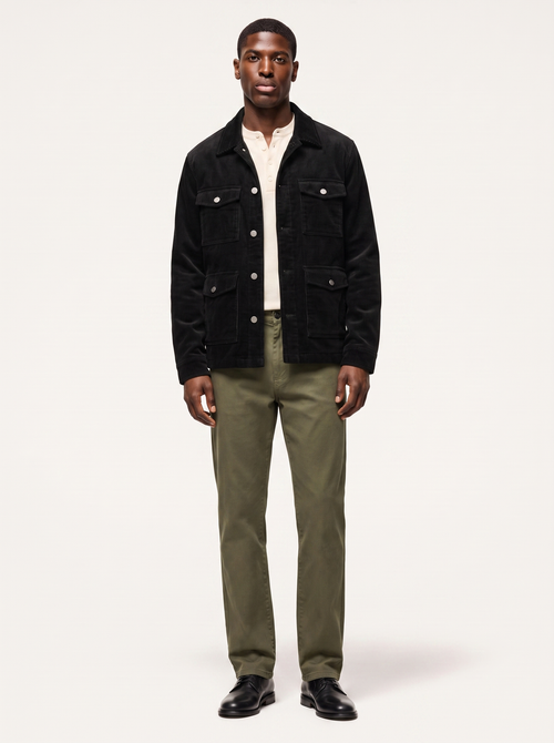 Black corduroy cargo jacket with flap pockets worn by model, front view on white