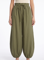 Balloon pants gathered high waistband and tapered leg close up detail