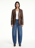 Vintage washed brown faux leather blazer worn by model, front view on white