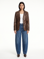 Vintage washed brown faux leather blazer worn by model, front view on white