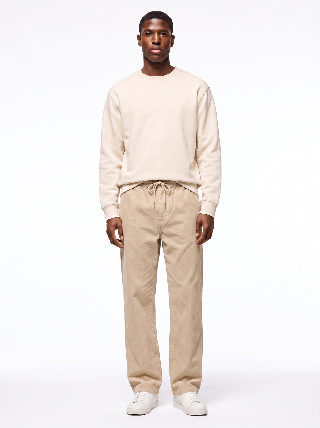 Beige wide leg corduroy pants worn by model, front view on white