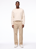 Beige wide leg corduroy pants worn by model, front view on white