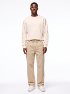 Beige wide leg corduroy pants worn by model, front view on white