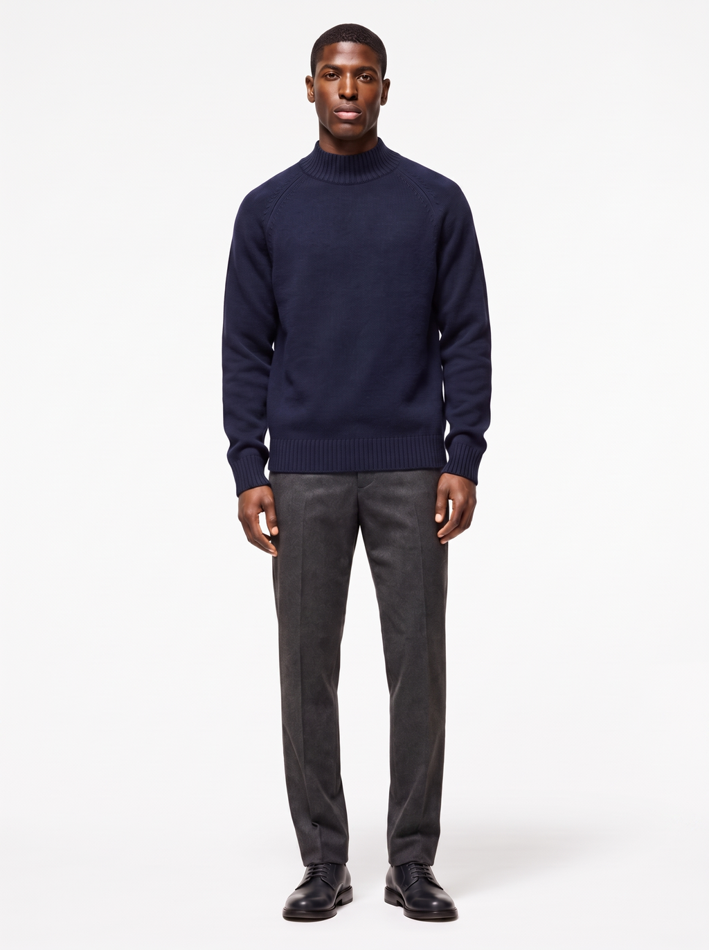 Navy mock neck raglan sweater worn by model, front view on white