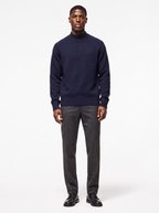 Navy mock neck raglan sweater worn by model, front view on white