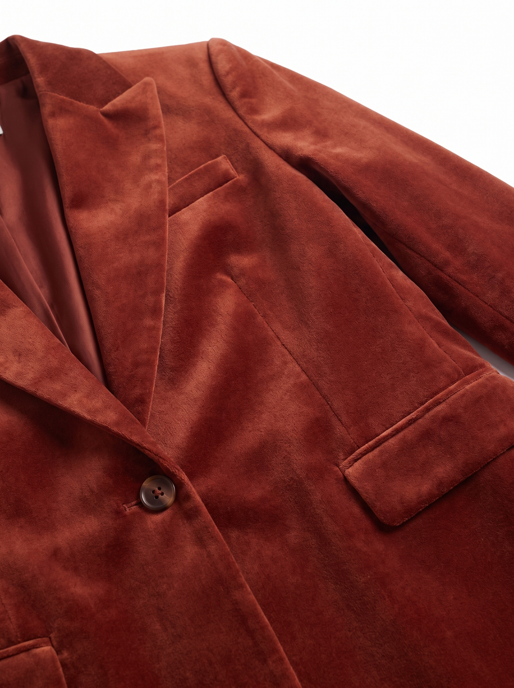 Velvet blazer lapel and single button close up detail