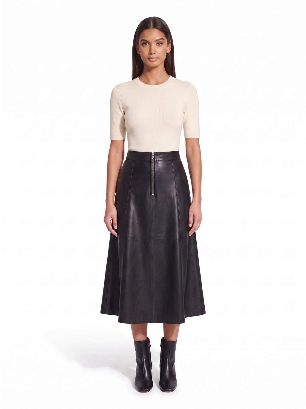 Black faux leather flared midi skirt worn by model, front view on white