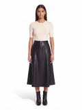 Black faux leather flared midi skirt worn by model, front view on white