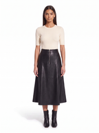 Black faux leather flared midi skirt worn by model, front view on white
