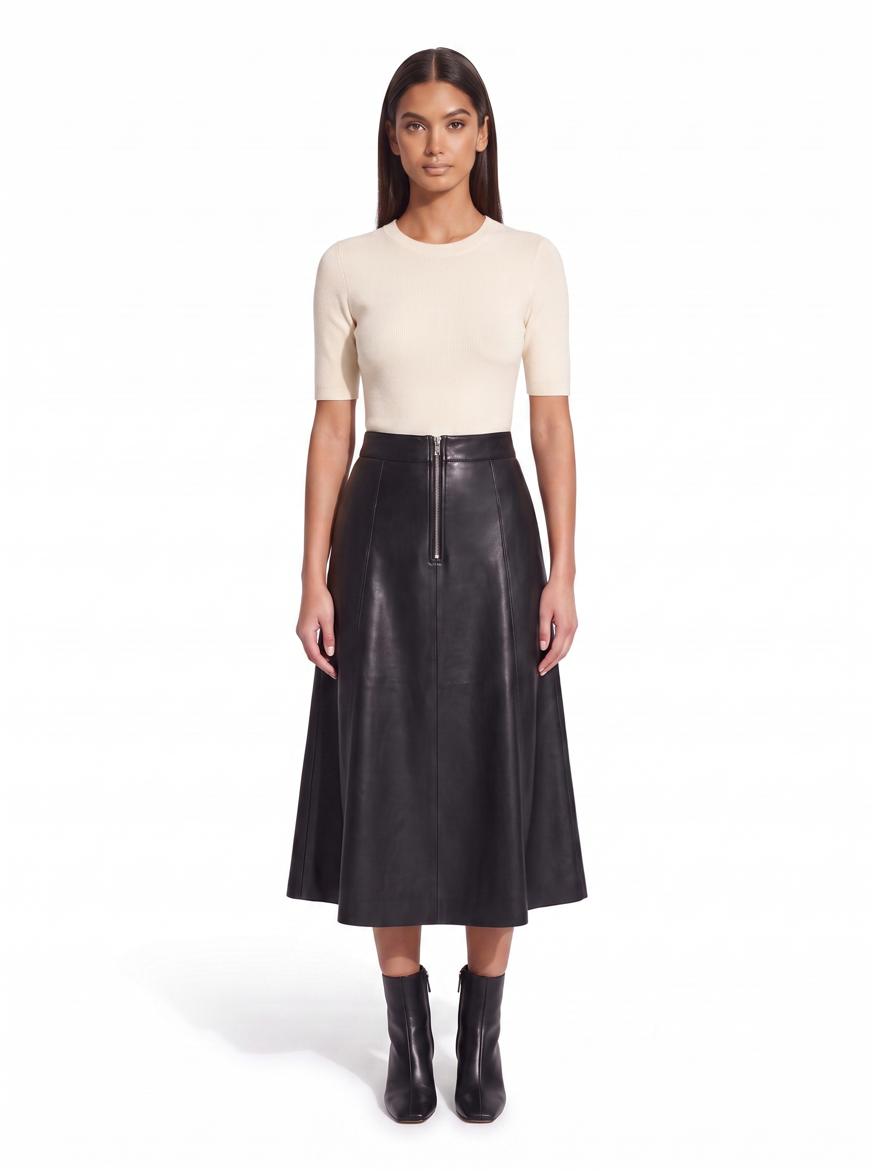 Black faux leather flared midi skirt worn by model, front view on white