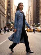 Woman wearing denim duster on city street in afternoon light, lifestyle