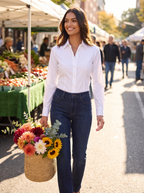 Woman wearing dark bootcut jeans at sunny outdoor market, lifestyle