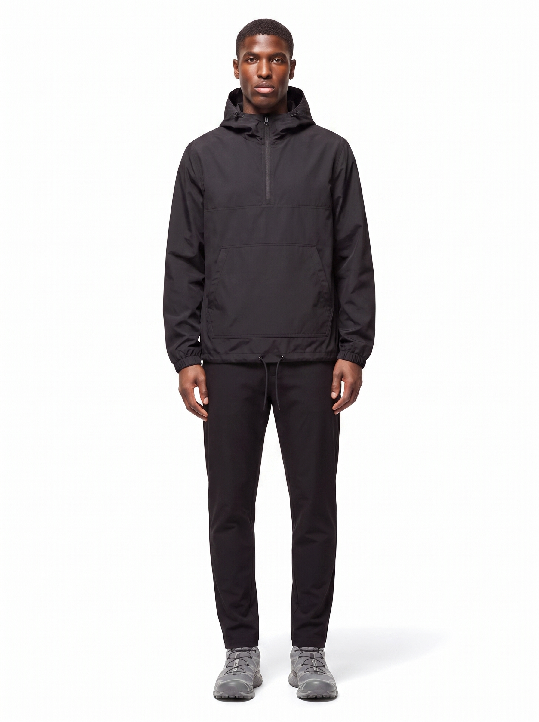 Black half zip hooded anorak worn by model, front view on white
