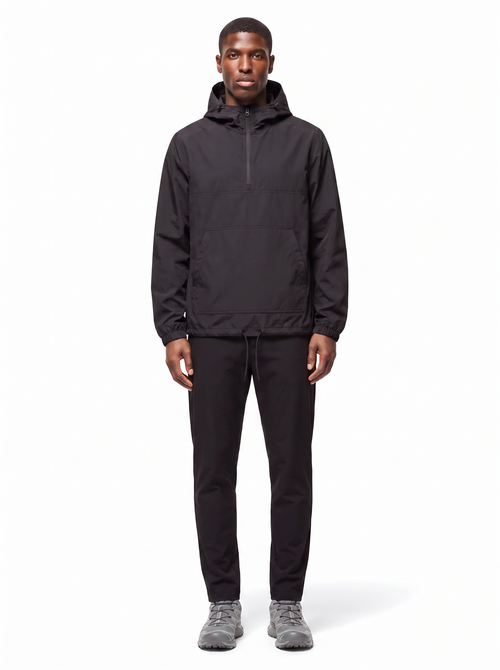 Black half zip hooded anorak worn by model, front view on white