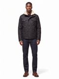 Black waxed canvas jacket with sherpa collar worn by model, front view on white