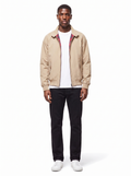 Beige harrington jacket with plaid lining worn by model, front view on white
