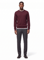Deep burgundy crew neck sweater worn by model, front view on white