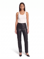 Black high waist faux leather pants worn by model, front view on white