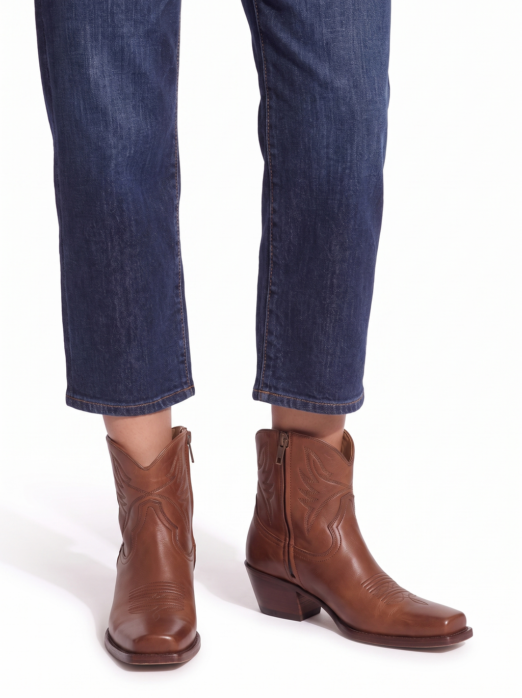 Western ankle boots worn with cropped jeans view