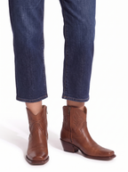 Western ankle boots worn with cropped jeans view