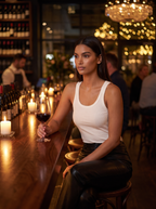 Woman wearing faux leather pants at evening wine bar, lifestyle