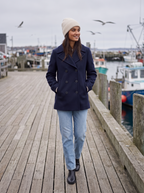 Navy pea coat lifestyle harbor boardwalk