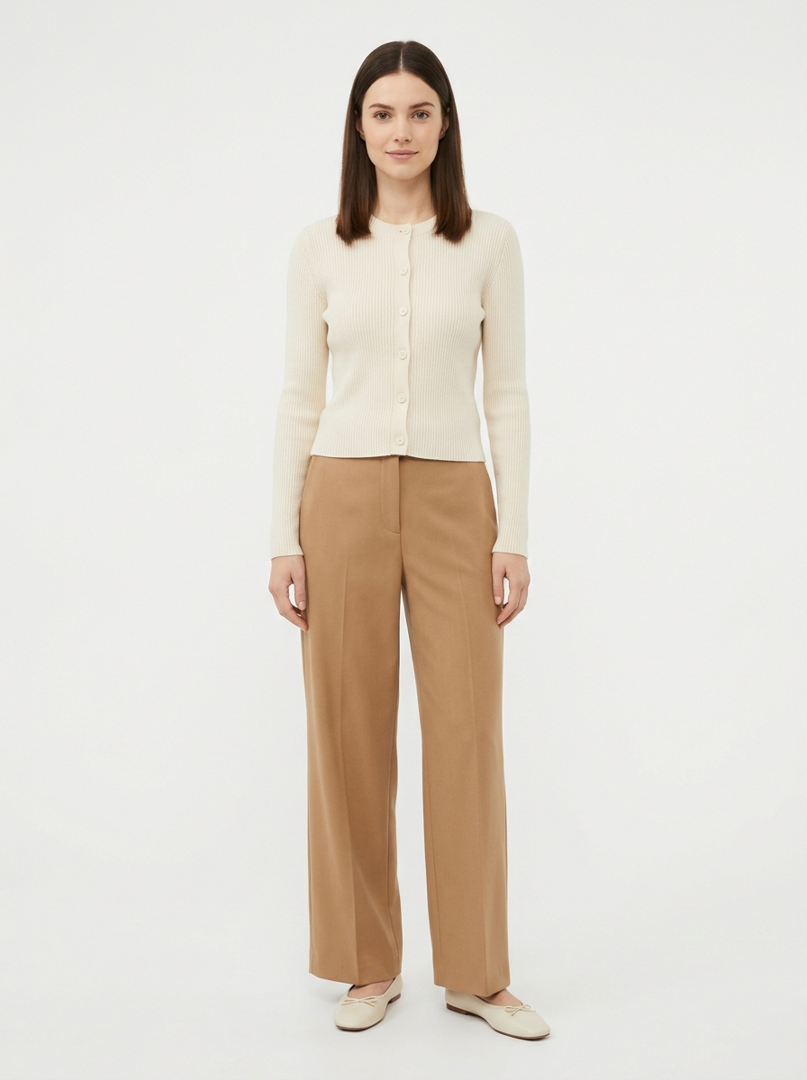 Cream ribbed knit cardigan worn by model, front view on white