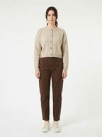 Oatmeal cropped cardigan worn by model, front view on white