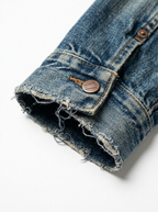 Frayed cuff edge and faded twill close up detail