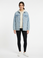 Light wash oversized denim jacket worn by model, front view on white