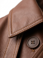 Lapel stitching and faux leather grain close up detail