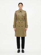 Khaki double breasted trench worn by model, front view on white