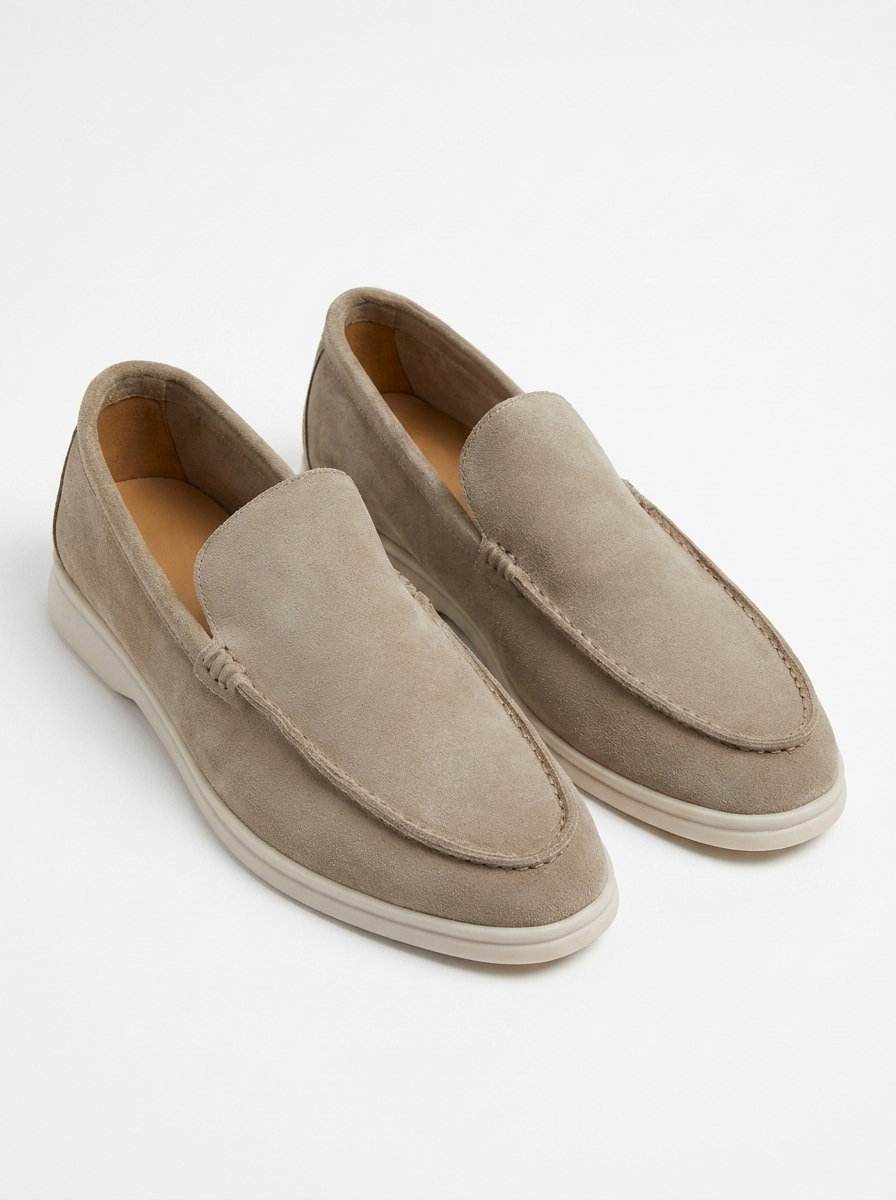 Beige suede laceless slip-on loafers, pair on white